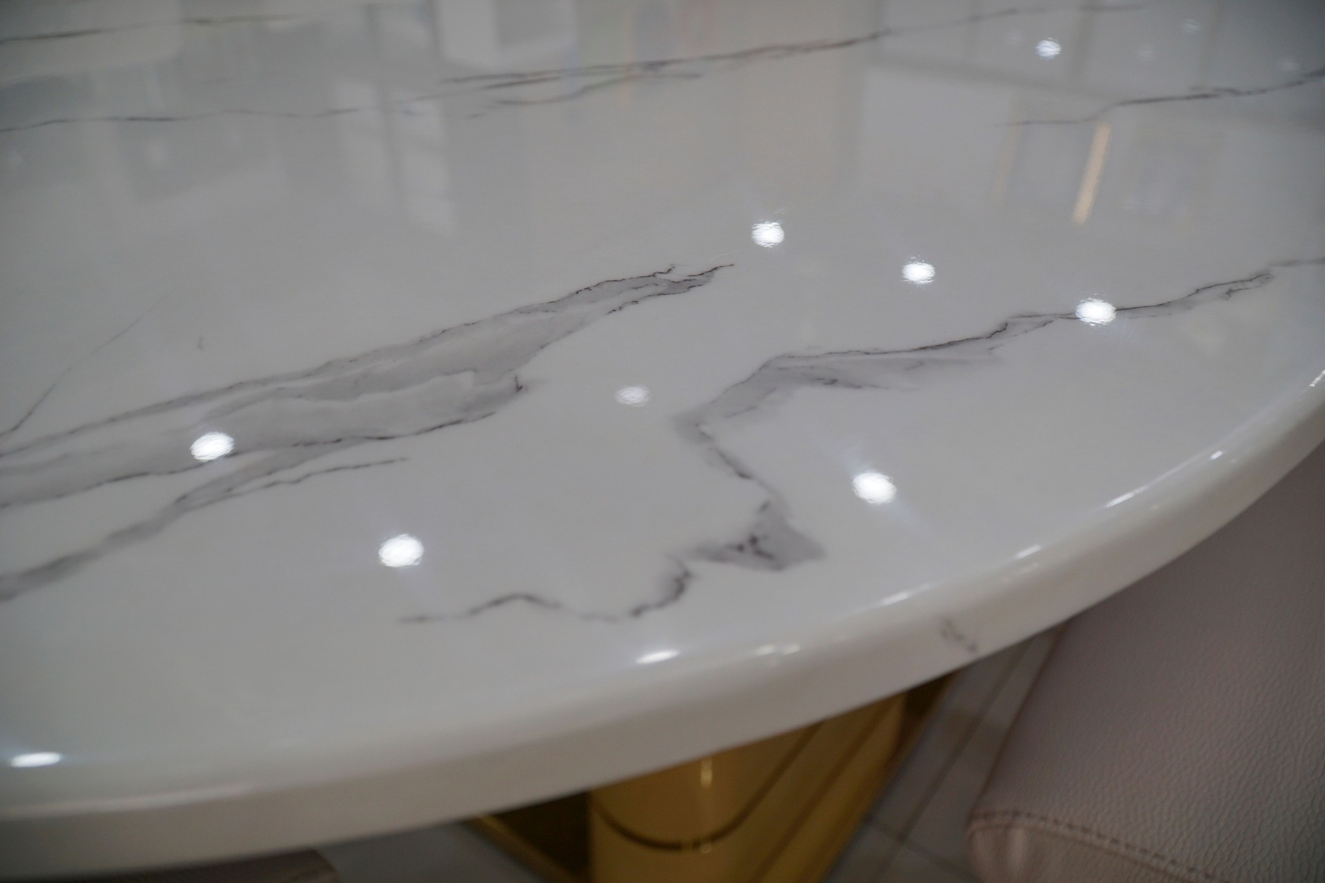 Luxury Marble stone top dining table and chairs set with golden color metal base and frame. Luxurious Dining set. Details of close up of chair and frame of table.